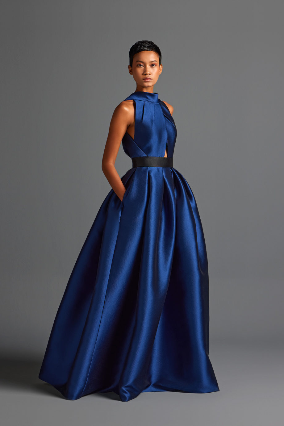 Asymmetrical box-pleated Satin gown with open back.